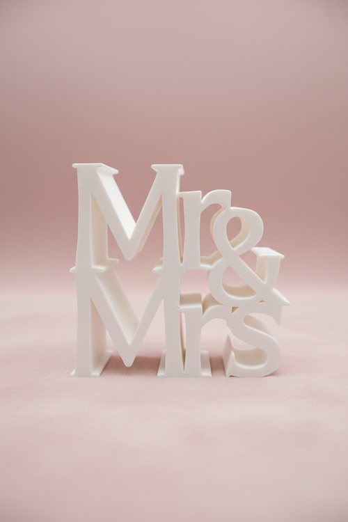 White 3D printed Mr & Mrs sign on soft blush champagne background with gentle shadow